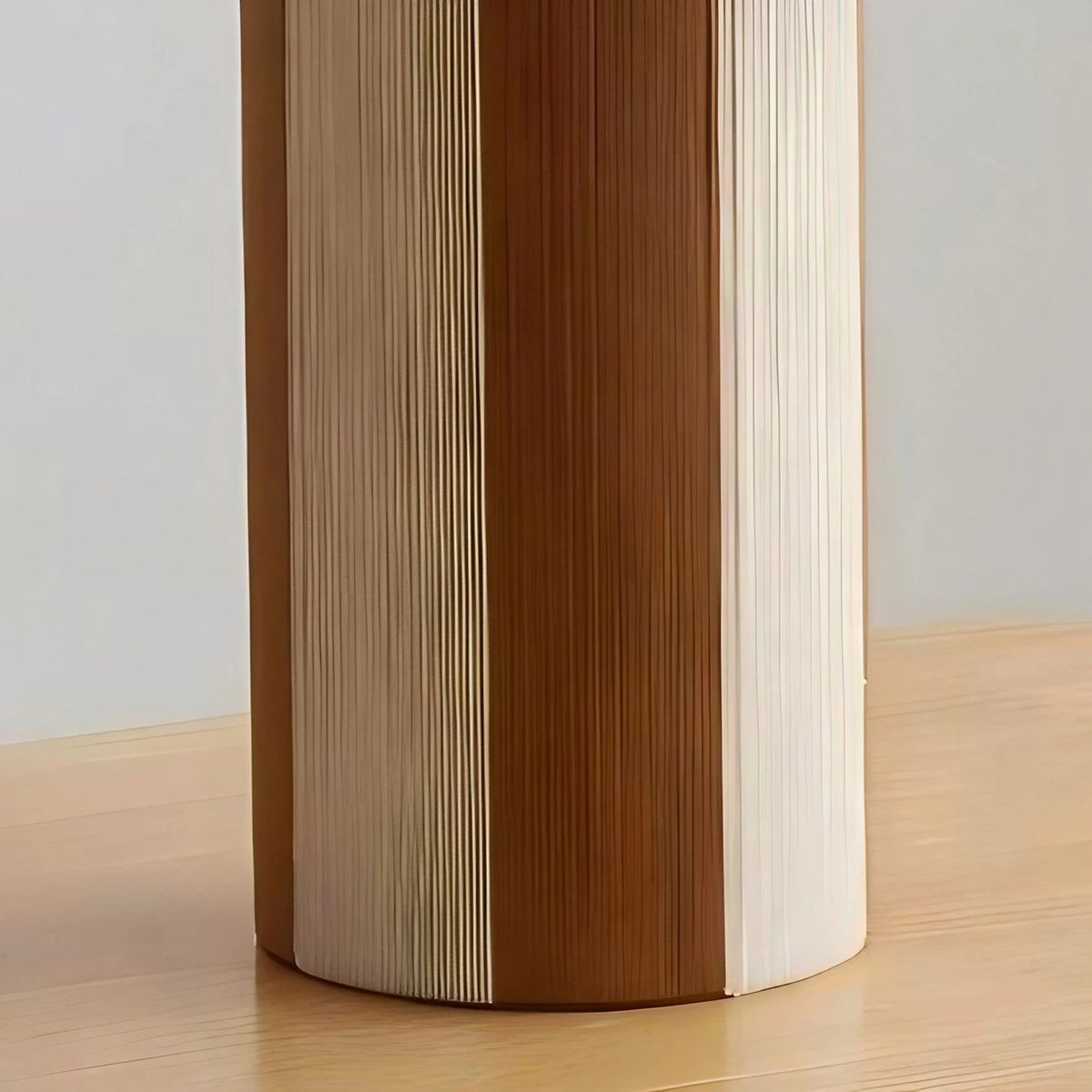 Cylindrical striped table lamp base with woven panel texture