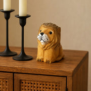 Wooden lion figurine styled on a cabinet