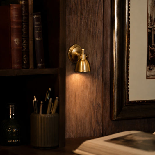 Brass wall lamp installed in a warm interior