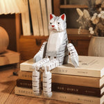Bild in die Galerieansicht laden, Hand-carved wooden cat ornament styled on a tabletop edge