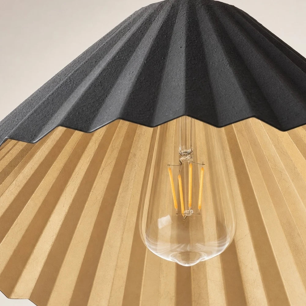 Black pleated metal shade and bulb detail