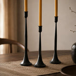 Carica l'immagine nella visualizzazione Galleria, Three black iron taper candle holders showing varied height and slim stems