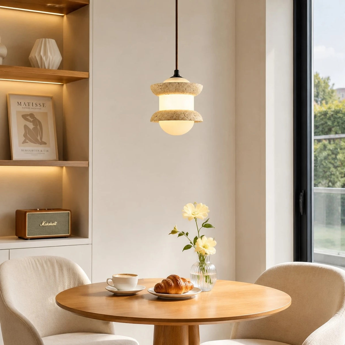 Single travertine stone pendant light above a small round table