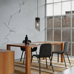Cargar imagen en el visor de la Galería, Black mesh stone pendant light over a dining table near a window