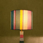 Charger l'image dans la visionneuse de la galerie, Colorful striped table lamp switched on with warm ambient light
