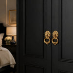 Afbeelding laden in galerijweergave, Brass ring pulls on a dark wardrobe