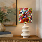 Bild in die Galerieansicht laden, Colorful floral shade table lamp styled beside books