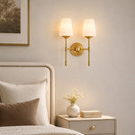 Carica l'immagine nella visualizzazione Galleria, Vintage brass wall light creating a warm bedroom atmosphere