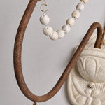Carica l'immagine nella visualizzazione Galleria, Close view of the curved iron arm and draped wood beads
