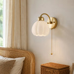Afbeelding laden in galerijweergave, Pull-chain milk glass flower wall lamp beside a bed