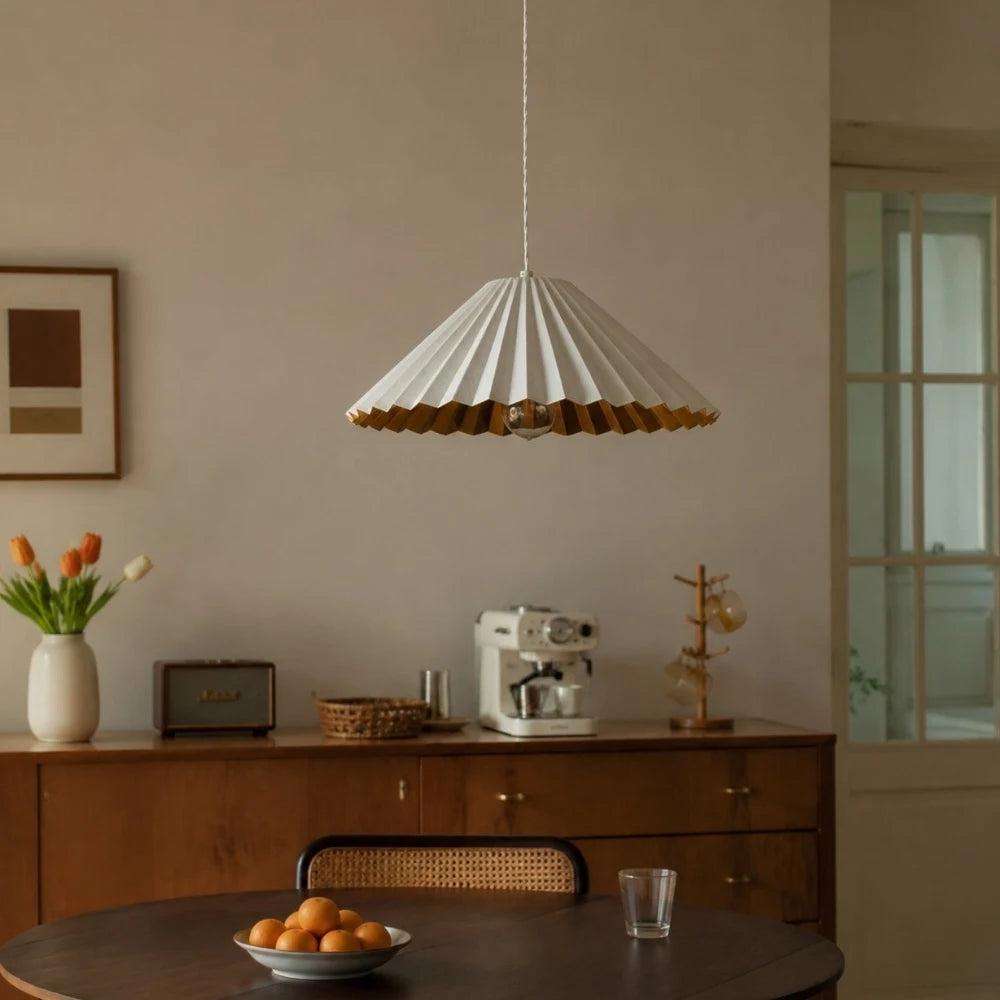 White pleated pendant lamp above a small dining table