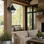 Load image into Gallery viewer, Black seeded-glass wall lamp styled in a quiet living space