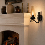 Afbeelding laden in galerijweergave, Kerosene style wall lamp glowing beside a fireplace mantel