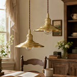 Load image into Gallery viewer, Two polished brass pendant lights in a vintage dining interior
