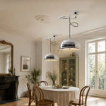 Cargar imagen en el visor de la Galería, Pair of adjustable chrome pendant lights in a bright dining room