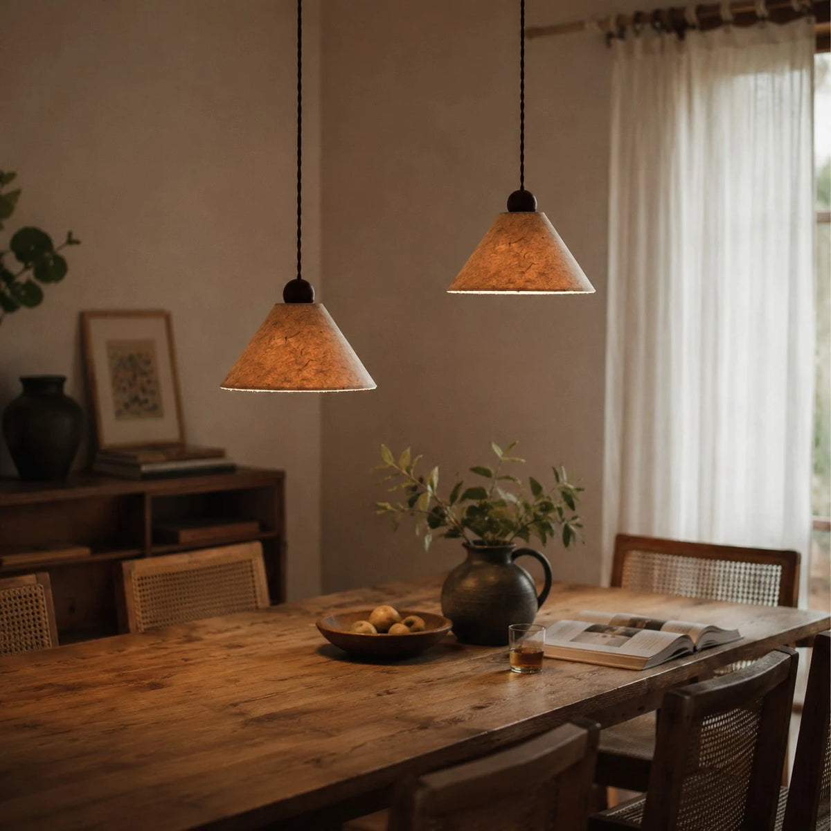 Warm lit natural paper pendant lamps in a dining room