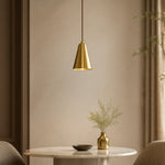 Afbeelding laden in galerijweergave, Tapered natural brass pendant light above a round dining table