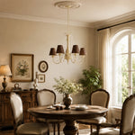 Load image into Gallery viewer, Brown-shade chandelier suspended in a warm traditional dining room