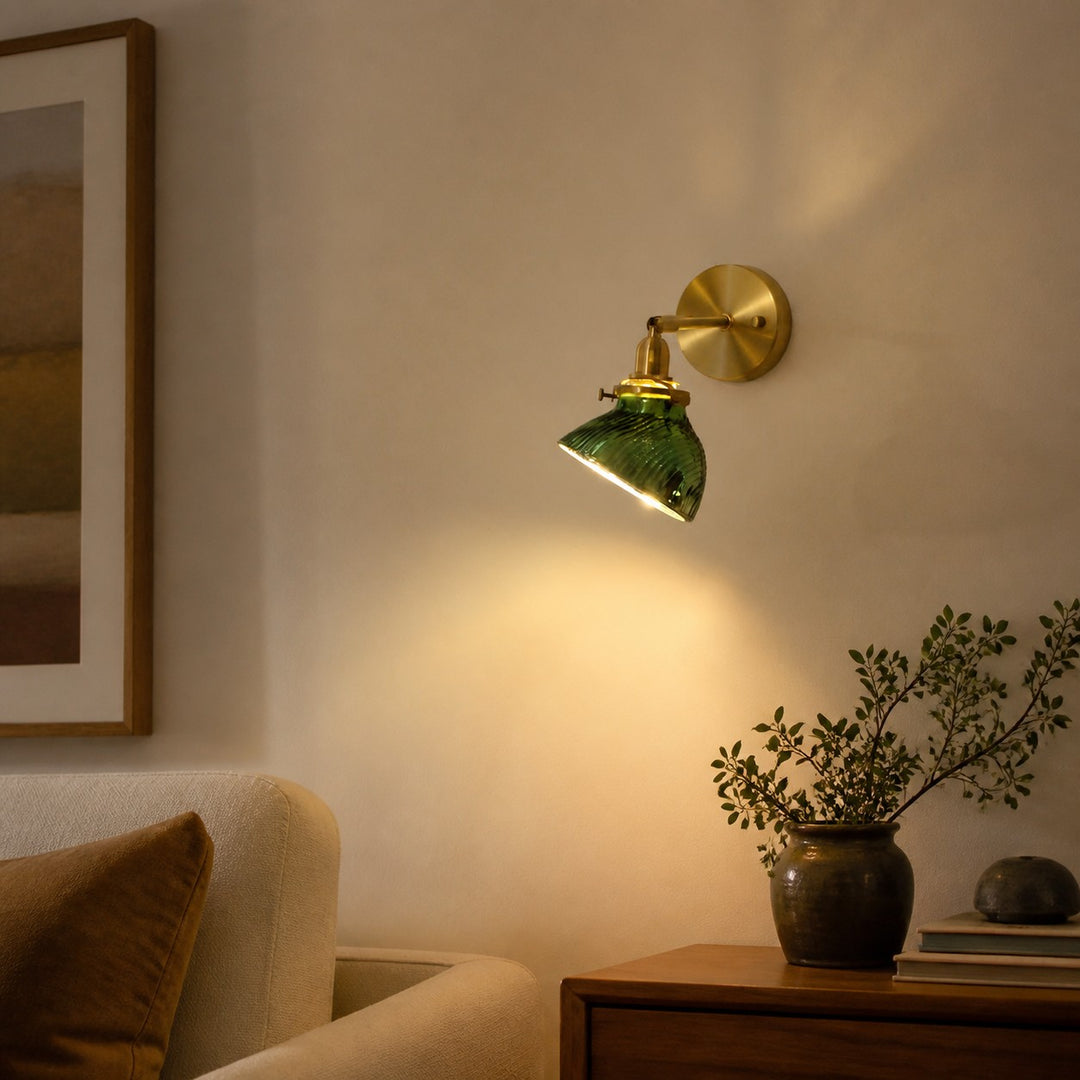 Green glass bedside wall lamp in a reading corner
