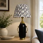 Charger l'image dans la visionneuse de la galerie, Matte black floral table lamp styled beside a green armchair
