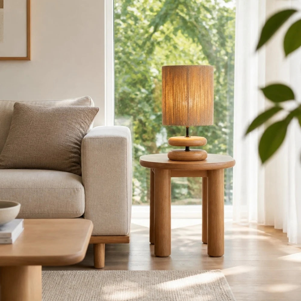 Natural wood table lamp beside a sofa in a bright living room