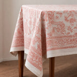 Load image into Gallery viewer, Soft coral floral tablecloth draped over a table corner