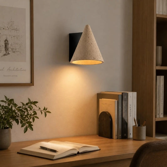 Desk corner scene with warm travertine wall light