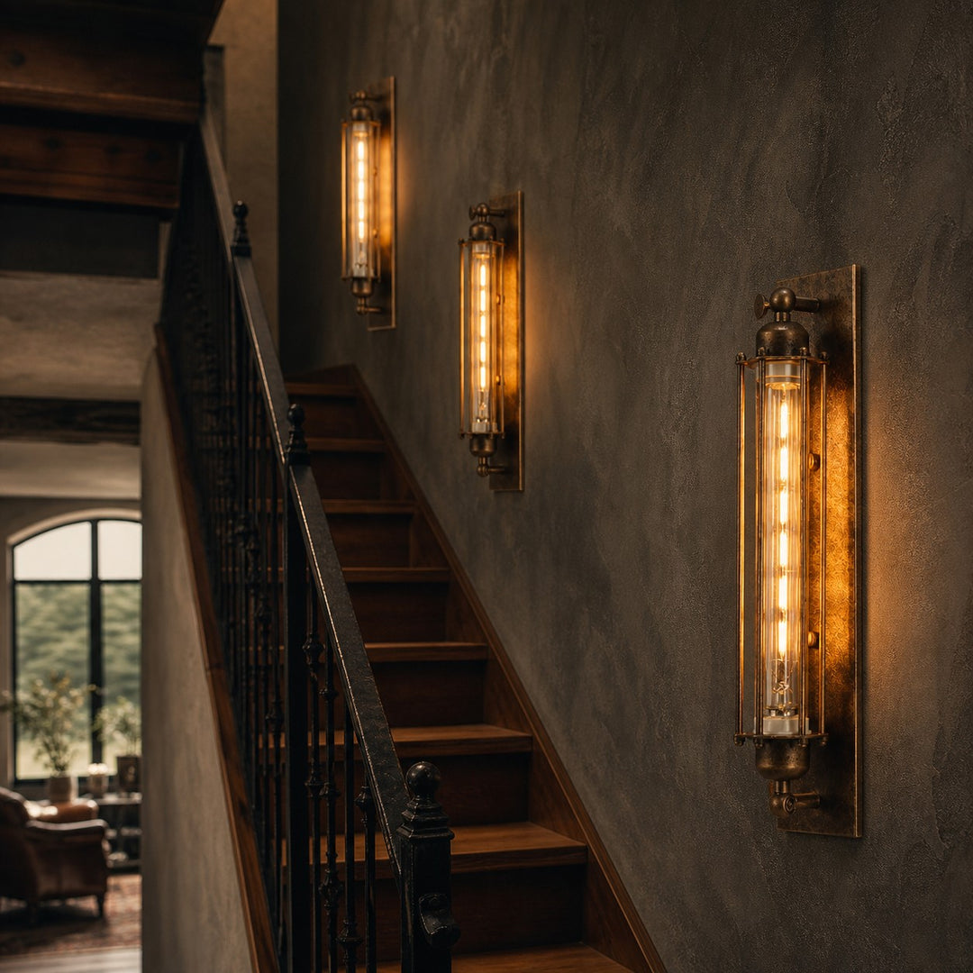 Industrial tube wall sconces along a stair wall
