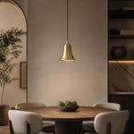 Afbeelding laden in galerijweergave, Bell-shaped natural brass pendant light in a warm dining room