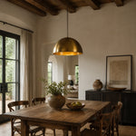 Load image into Gallery viewer, Brass dome pendant light in a dining room with wood furniture