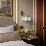 Afbeelding laden in galerijweergave, Blue milk glass brass wall sconce beside a bed