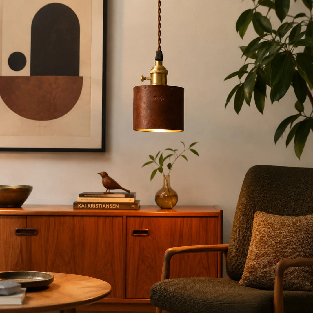 Brown leather pendant lamp lit in a warm vintage living room