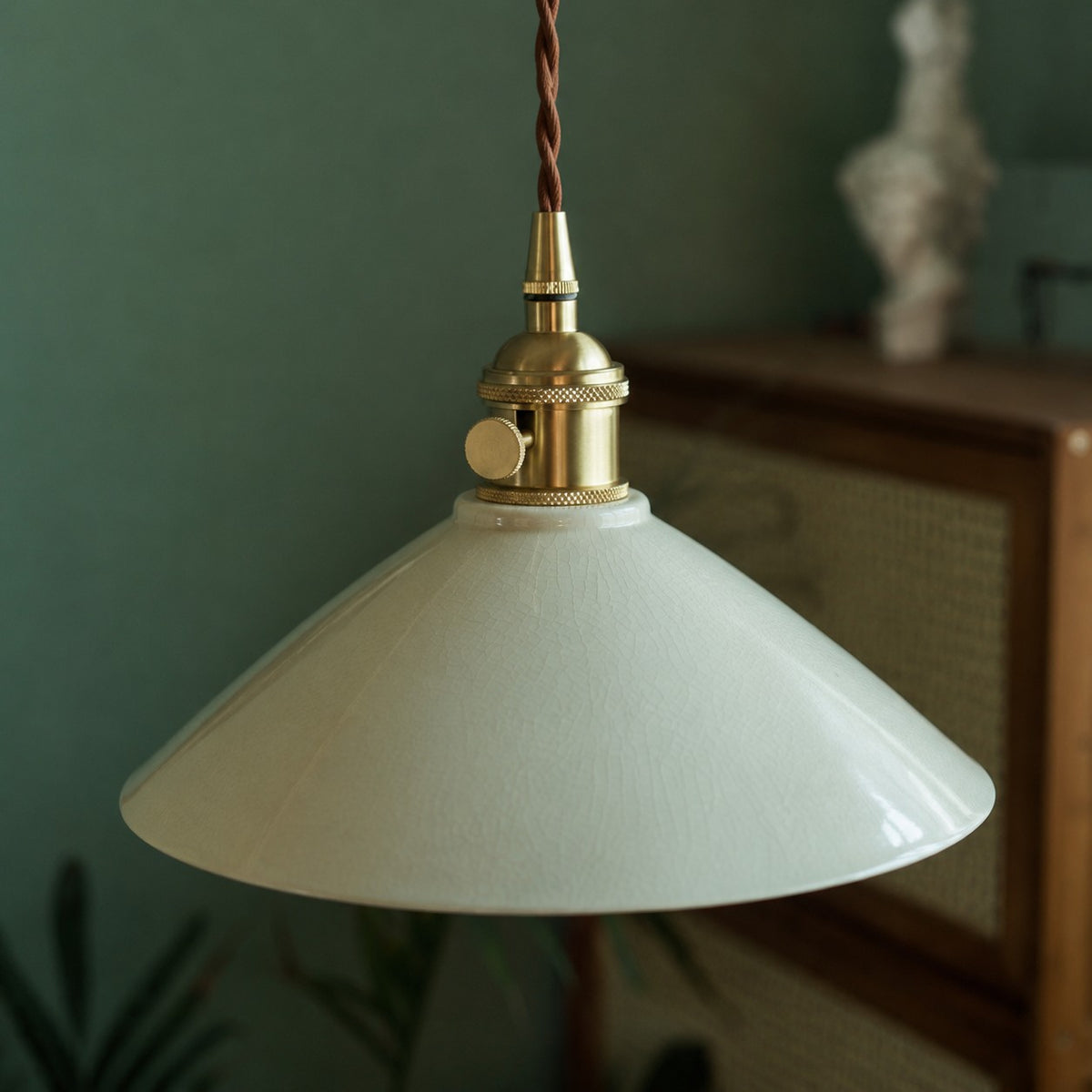 Brass-tone socket and ceramic shade detail