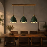 Cargar imagen en el visor de la Galería, Three green leather pendant lights above a dining table