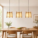 Bild in die Galerieansicht laden, Natural wood fabric pendant lights in a bright dining room