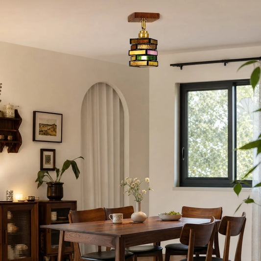 Multicolor glass pendant lamp above a dining table