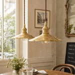 Load image into Gallery viewer, Pair of polished brass pendant lights above a dining table