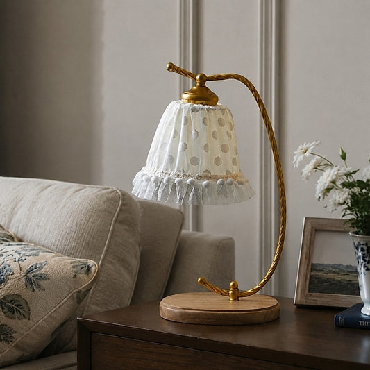 Lace shade table lamp on a side table in a soft neutral room