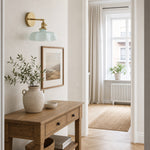 Afbeelding laden in galerijweergave, Blue milk glass brass wall sconce above an entry console