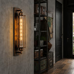 Afbeelding laden in galerijweergave, Antique brass tube wall sconce in a loft hallway