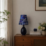 Afbeelding laden in galerijweergave, Blue floral fabric ceramic table lamp on a wooden cabinet