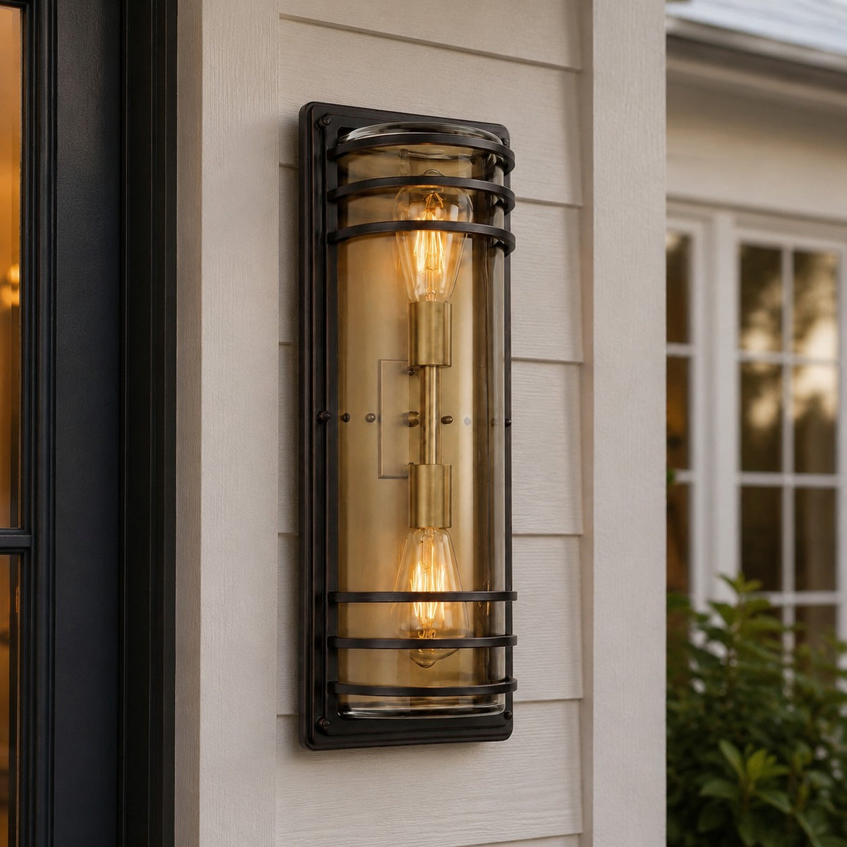 Large bronze glass outdoor wall sconce installed on a porch wall