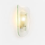 Afbeelding laden in galerijweergave, Clear glass wall sconce shown illuminated on a white background