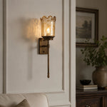 Cargar imagen en el visor de la Galería, Brass amber glass wall sconce installed in a living room