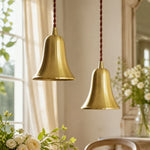 Carica l'immagine nella visualizzazione Galleria, Pair of natural brass bell pendant lights in an elegant interior
