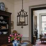 Cargar imagen en el visor de la Galería, Rustic birdcage pendant lamp installed above a dining room table