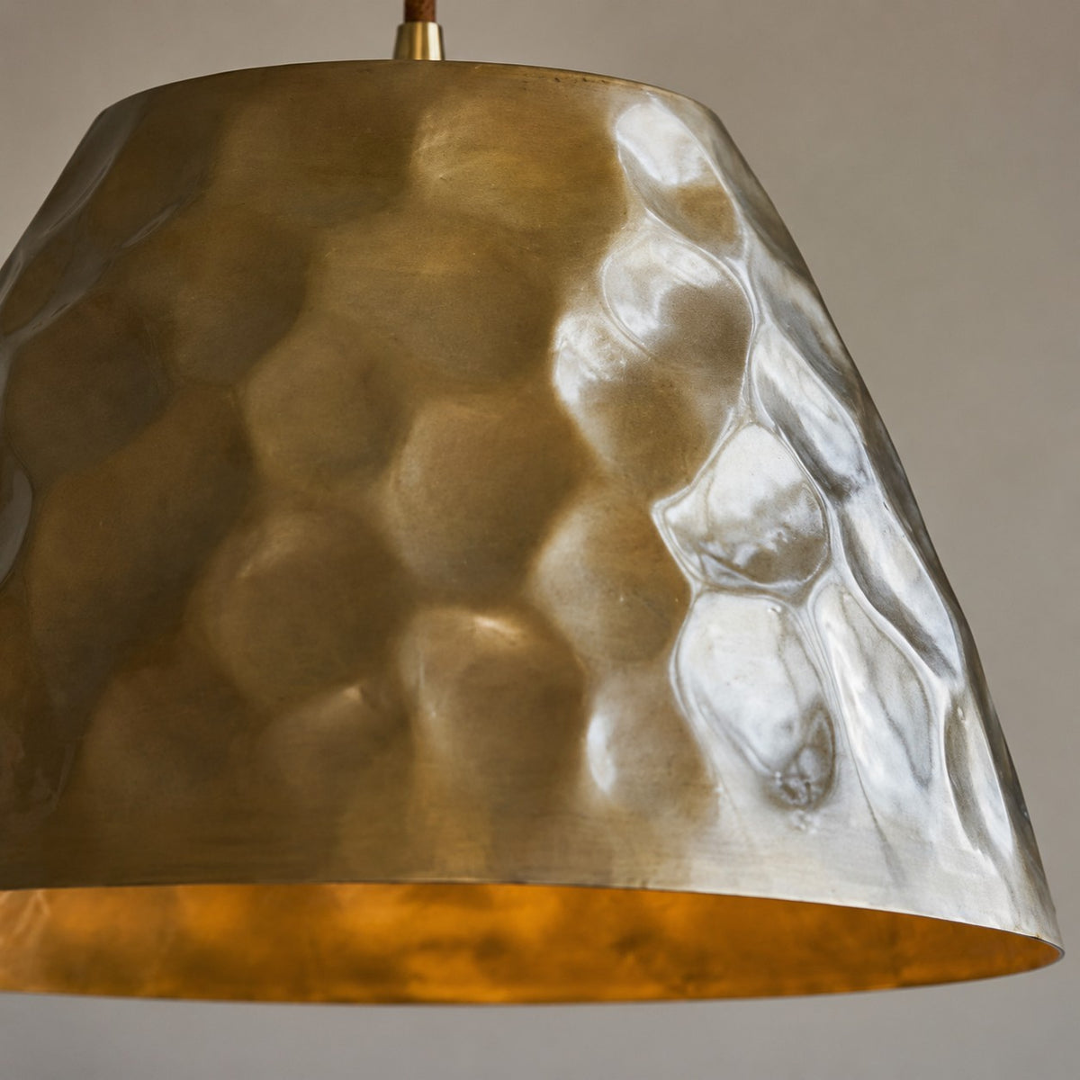 Close-up of hammered metal texture on the brass shade