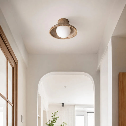 Natural wood ceiling light installed in a hallway