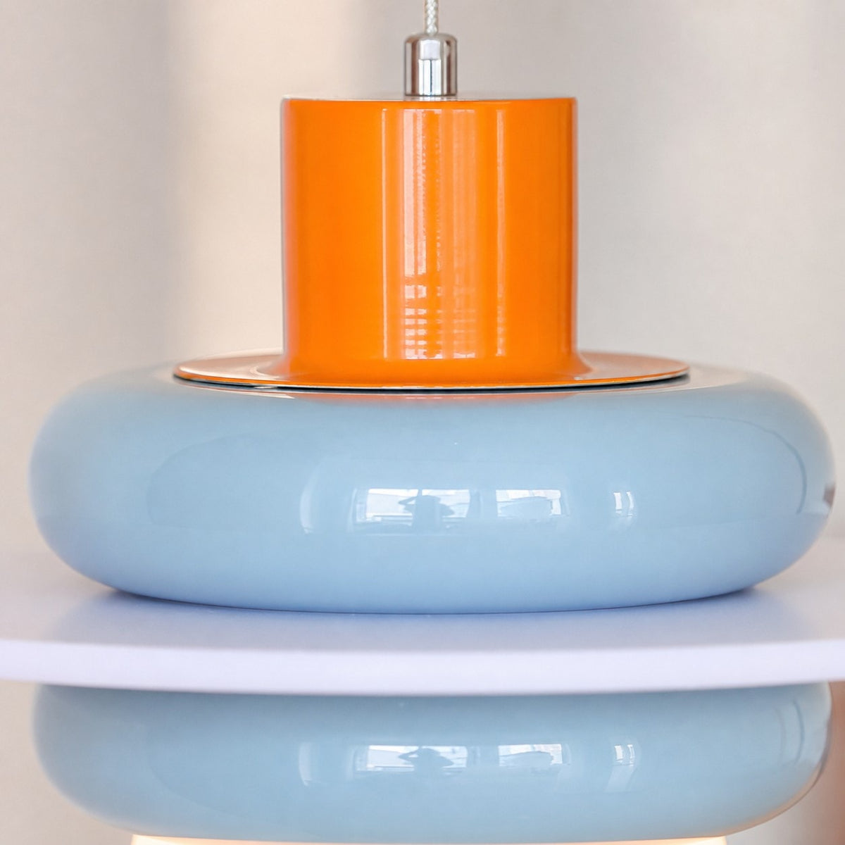 Close-up of sea salt blue layered shade and orange accent