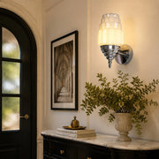 Chrome white glass wall sconce above an entry console